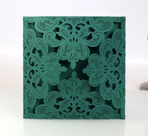 Detailed laser-cut European style white wedding invitation card with intricate floral hollows