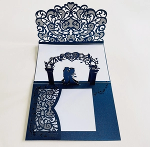 Detail of 3D laser cut wedding invitation card featuring blue hollow floral patterns