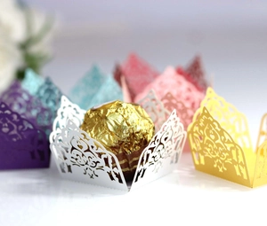 Laser cut hollow paper lace wrappers for chocolate and cupcakes in vibrant mixed colors