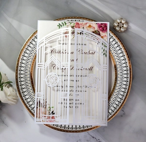 Macro view of laser-cut rose gate wedding invitation on an elegant porcelain plate
