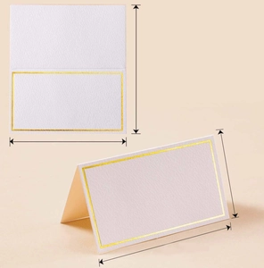 Detail view of white place card with gold foil border showing dimensions and folding structure