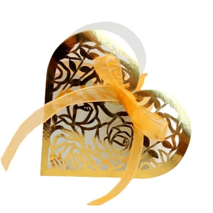 Elegant gold laser-cut heart favor box with rose patterns and yellow ribbon for weddings