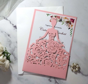 Detail of pink laser-cut wedding invitation featuring a floral girl silhouette and rose insert