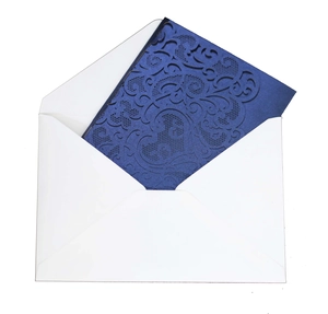 Detail of laser-cut navy blue wedding invitation card with elegant vine patterns