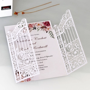 Close-up of laser cut gatefold wedding invitation with pink peony floral inner card detail