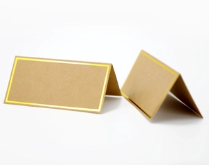 Elegant folded brown kraft place cards featuring a refined gold foil border design