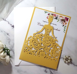 Detail of laser-cut gold wedding invitation with rose pattern and elegant bride silhouette