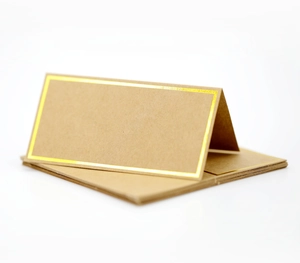 Foldable white place cards with elegant gold foil borders for weddings and formal events