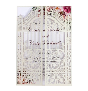 Detail of laser-cut wedding invitation with elegant gate-fold floral patterns and inner card