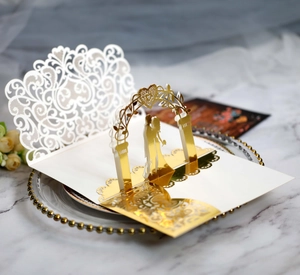 Exquisite 3D laser-cut wedding invitation with golden groom and bride pop-up detail