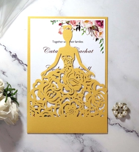 Detail of laser-cut gold bridal silhouette invitation with intricate rose lace patterns