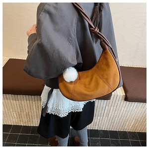 Sac hobo en daim marron avec breloque peluche blanche et bandoulière en cuir noué