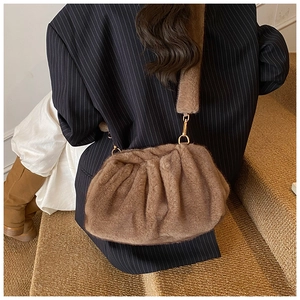Detail view of light brown ruched plush cloud bag with soft faux fur texture and gold hook