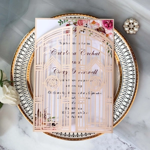 Detail of laser-cut rose gold wedding invitation with intricate floral hollow patterns