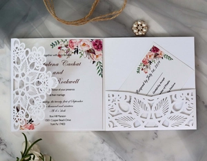 Elegant laser-cut white wedding invitation set with floral card and rustic twine decoration