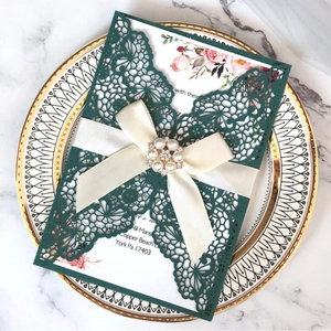 Laser cut dark green wedding invitation set with floral card and pearl ribbon decoration