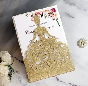 Macro detail of laser-cut gold glitter princess dress invitation and floral insert card