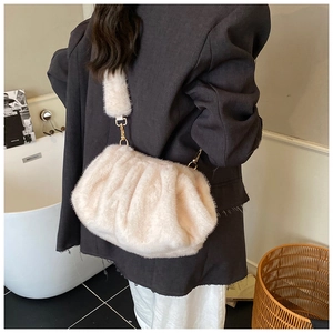 Detail view of plush ruched cloud bag with thick faux fur and golden metal buckle