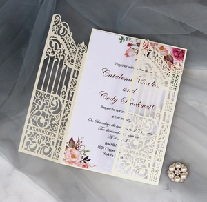 Detail of laser-cut wedding invitation with cream gate pattern and floral inner card