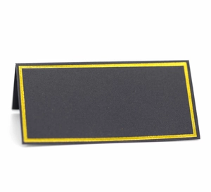 Detail shot of black place card with elegant gold foil border for luxury wedding tables