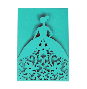 Macro detail of laser-cut turquoise invitation featuring a lady in floral hollowed gown