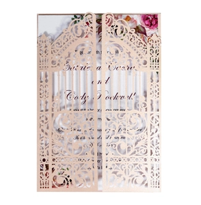 Detail of laser cut champagne gold glitter wedding invitation with vintage gate design
