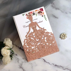 Detail view of rose gold glitter laser-cut wedding invitation featuring a princess dress silhouette