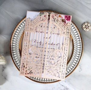 Detail of rose gold laser-cut gate wedding invitation with floral insert on porcelain
