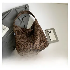 Detail view of Leopard print hobo bag with MALIVI brand label on a soft neutral background