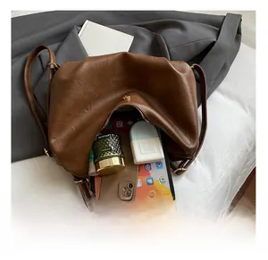 Spacious interior of brown faux leather tote bag showing tablet and essentials storage