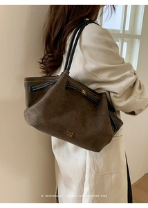 Macro shot of minimalist retro tote bag side detail featuring dark coffee matte leather and drawstring