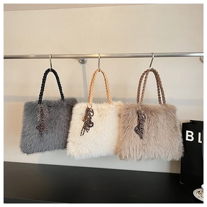 Detail showing the plush faux fur texture and woven rope handles of three tote bags