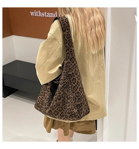 Detail view of large leopard print tote bag showing soft texture and spacious slouchy design