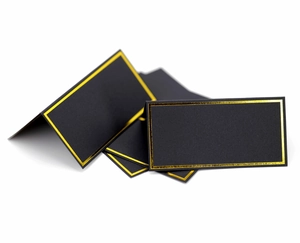 Detailed view of black place cards with elegant gold foil edges and folding design