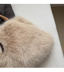 Detailed macro view of beige faux fur texture with woven handle and drawstring closure
