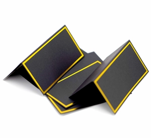Macro shot of black paper place cards with elegant gold foil borders and folded design