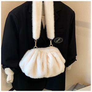 Close-up of cream white plush cloud bag with soft ruched texture and gold metal buckle