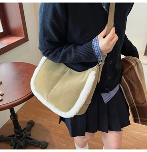 Detail of khaki suede crossbody bag with white faux fur trim styled on a female model