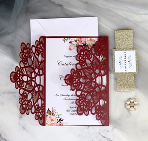 Elegant laser cut burgundy wedding invitation set with pearl buckle and gold glitter belt