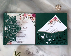 Detailed laser-cut mandala design on dark green wedding invitation with elegant floral cards