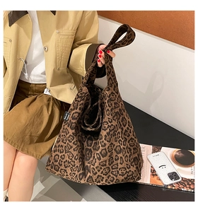 Close-up of leopard print tote bag side detail showing MALIVI brand woven label