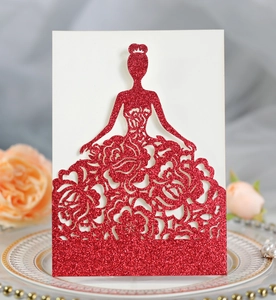 Macro detail of red glitter laser-cut invitation featuring a rose pattern gown design