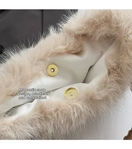 Detail of golden magnetic snap closure on a beige pleated faux fur tote bag