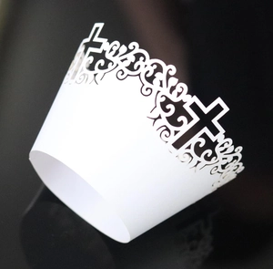White laser-cut cupcake wrapper featuring religious cross and floral vine patterns