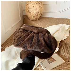 Detail of a dark brown plush cloud bag with soft ruched texture for autumn and winter style