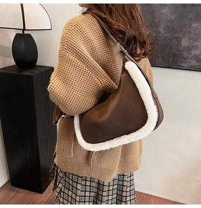 Detail of mocha suede tote bag with white faux fur trim and adjustable leather strap