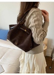 Detail shot of vintage dark brown suede tote bag with drawstring and golden PAN TOR logo
