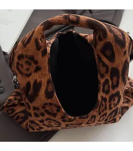 Close-up of leopard print suede handbag showing the open top design and soft texture