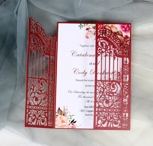 Close-up of red laser-cut wedding invitation gate with floral inner card detail