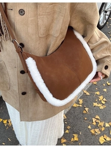 Brown suede hobo bag with white faux fur trim and adjustable crossbody strap for winter